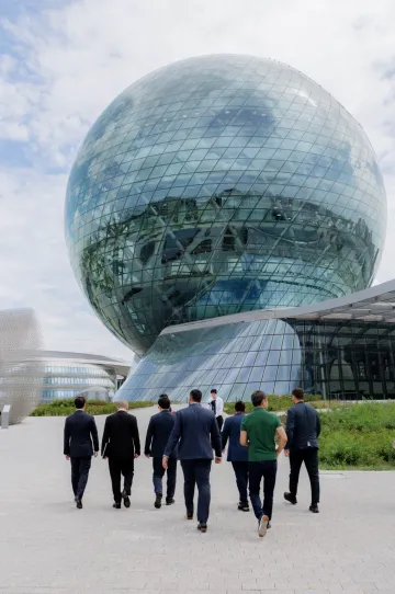 Kazakhstan officials approach the alem.ai sphere at the Astana Hub campus